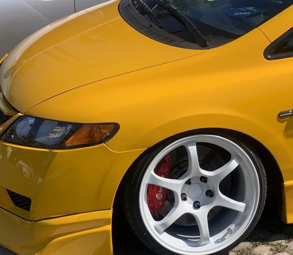 Two/Three-Piece Forged Wheels Two-piece forged wheels on a yellow Honda S2000 — white 6-spoke with red caliper