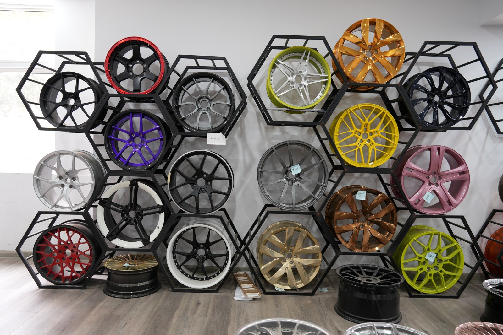 About Us Forged wheels on hexagon display racks in the VENXAN showroom